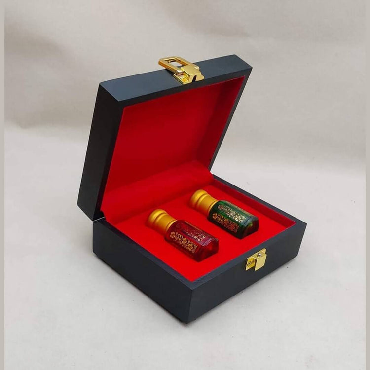 attar gift box black case with bright red interior holding two small gold capped Kannauj attar bottles