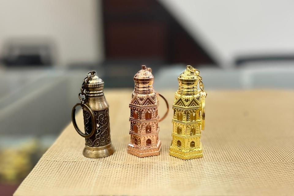 Kannauj Products ornate set of three metal mini refillable attar bottle keychain in bronze rose gold and gold finish